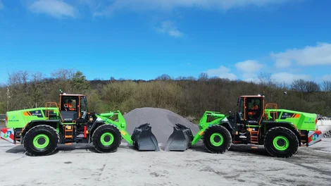 Two green-coloured Liugong 870HE electric loading shovels in front of a pile of aggregates waiting to be moved at Holcim's Callow hard rock quarry