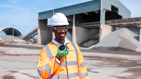 Regional Operations Manager Mustapha Nyass in high viz talking into his radio at the Sheffield asphalt plant.