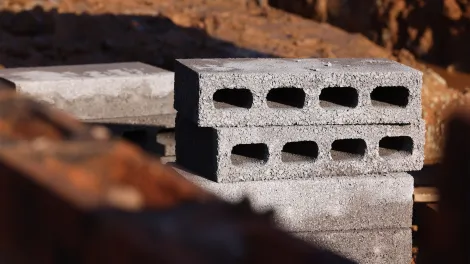 Breeze blocks stacked in a muddy environment 