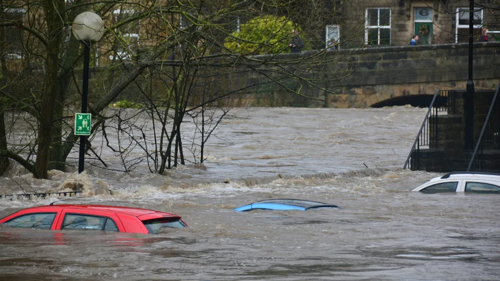 Floodwater submerging cars in a UK carpark