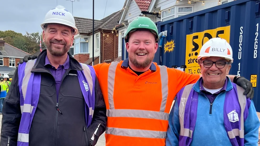 Chris Davison in orange PPE on the set of DIY SOS in Southampton with Nick Knowles and Billy Byrne from the show