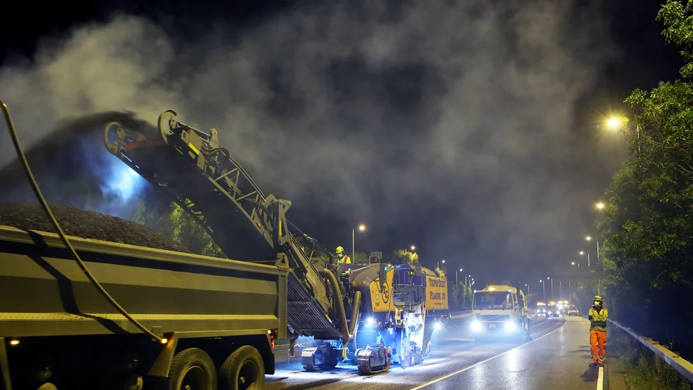 A planer removes the top surface of the road during works to resurface the M42 Motorway by Holcim