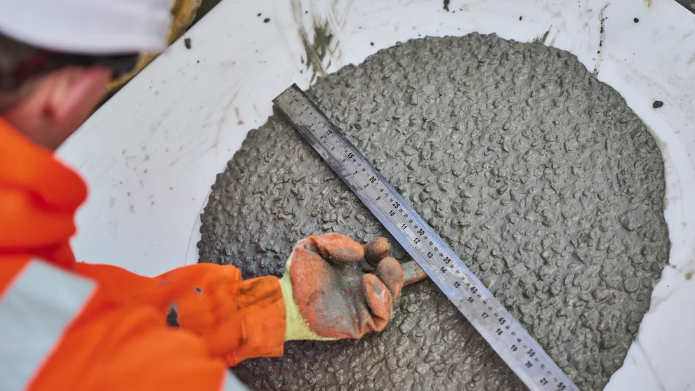 A worker measuring the slump of readymix