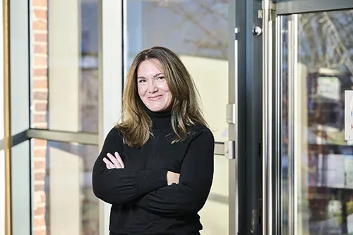 Lady with arms folded looking at the camera