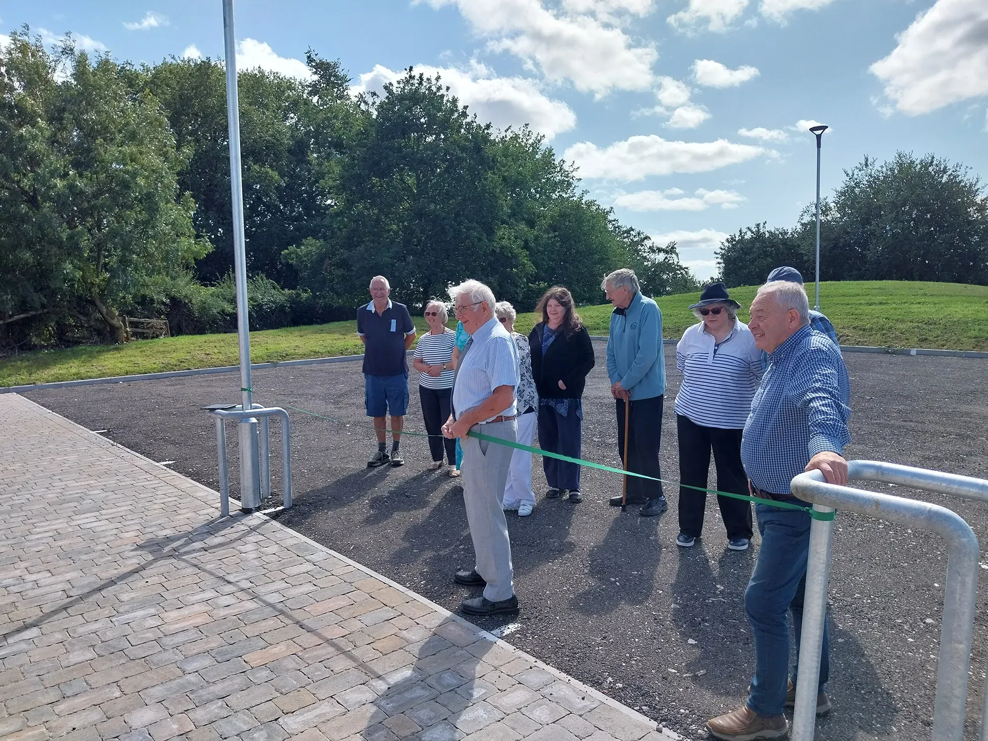 a group of people inspecting a newly built carpark outside
