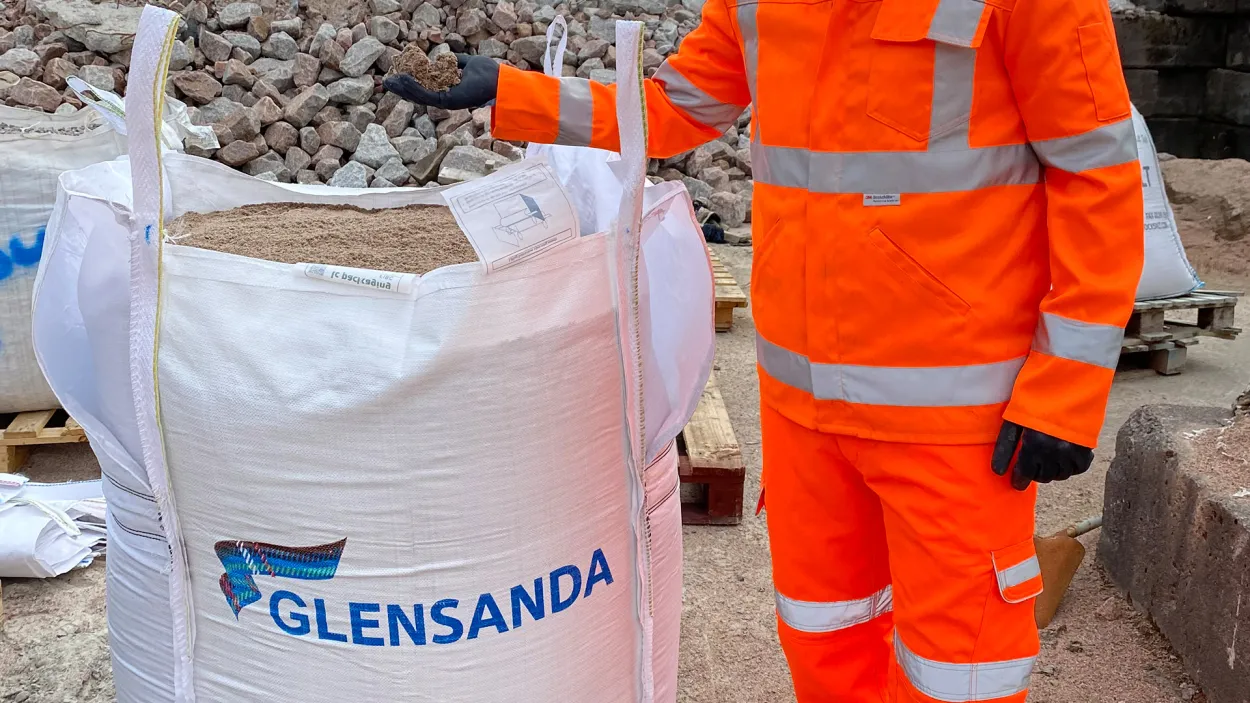 Man holding Glensanda bagged sand