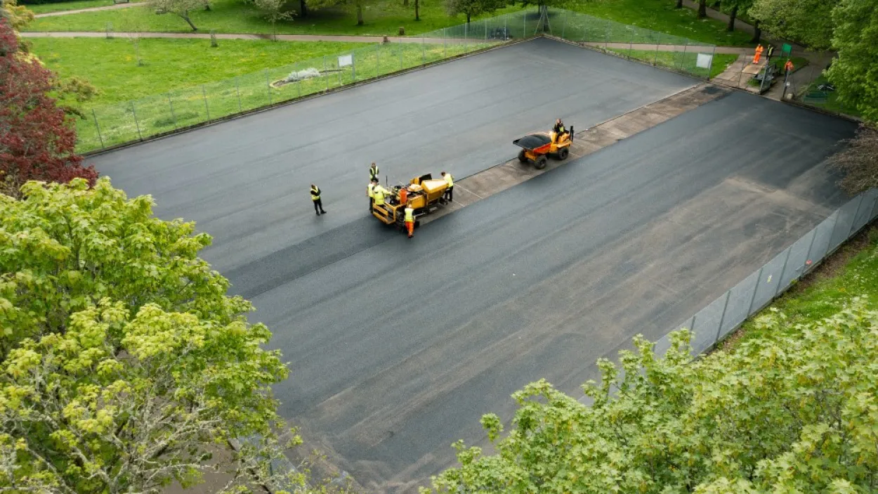 Aerial image of SuperSport asphalt being layed onto a tennis court 