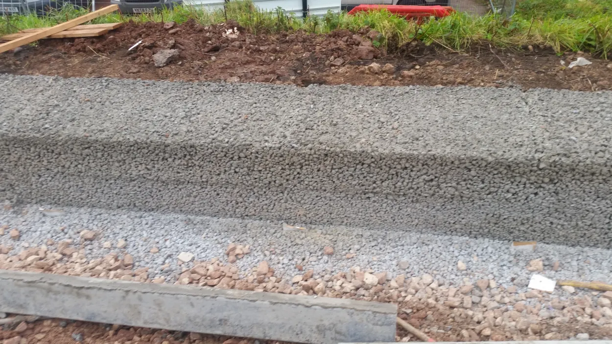 A water permeability demonstration showing water draining rapidly through Hydromedia porous concrete paving in Redditch.