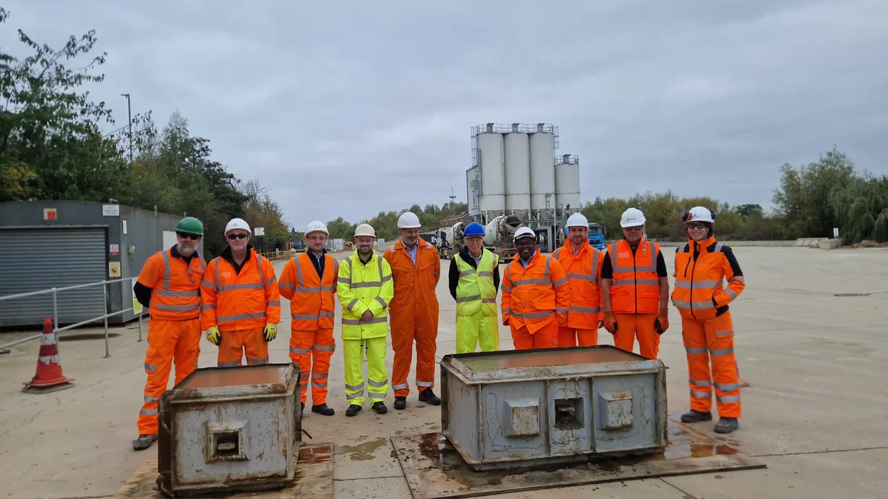 People wearing orange and yellow PPE standing in a line in front of the Whetstone Readymix plant.