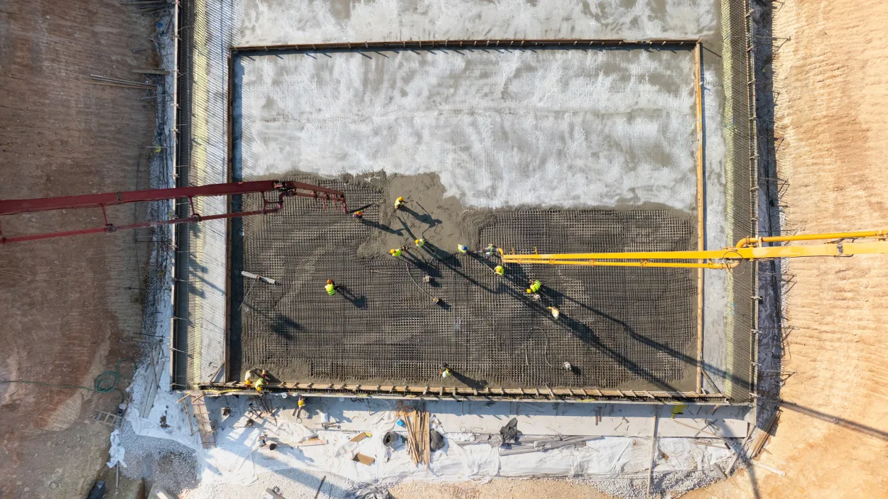 Top down image of concrete being poured on a new building