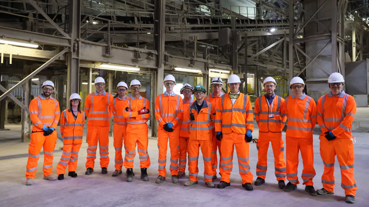 A group of Holcim Uk coleagues including CEO Lee Sleight in the Cauldon Cement Plant kiln building in high viz PPE