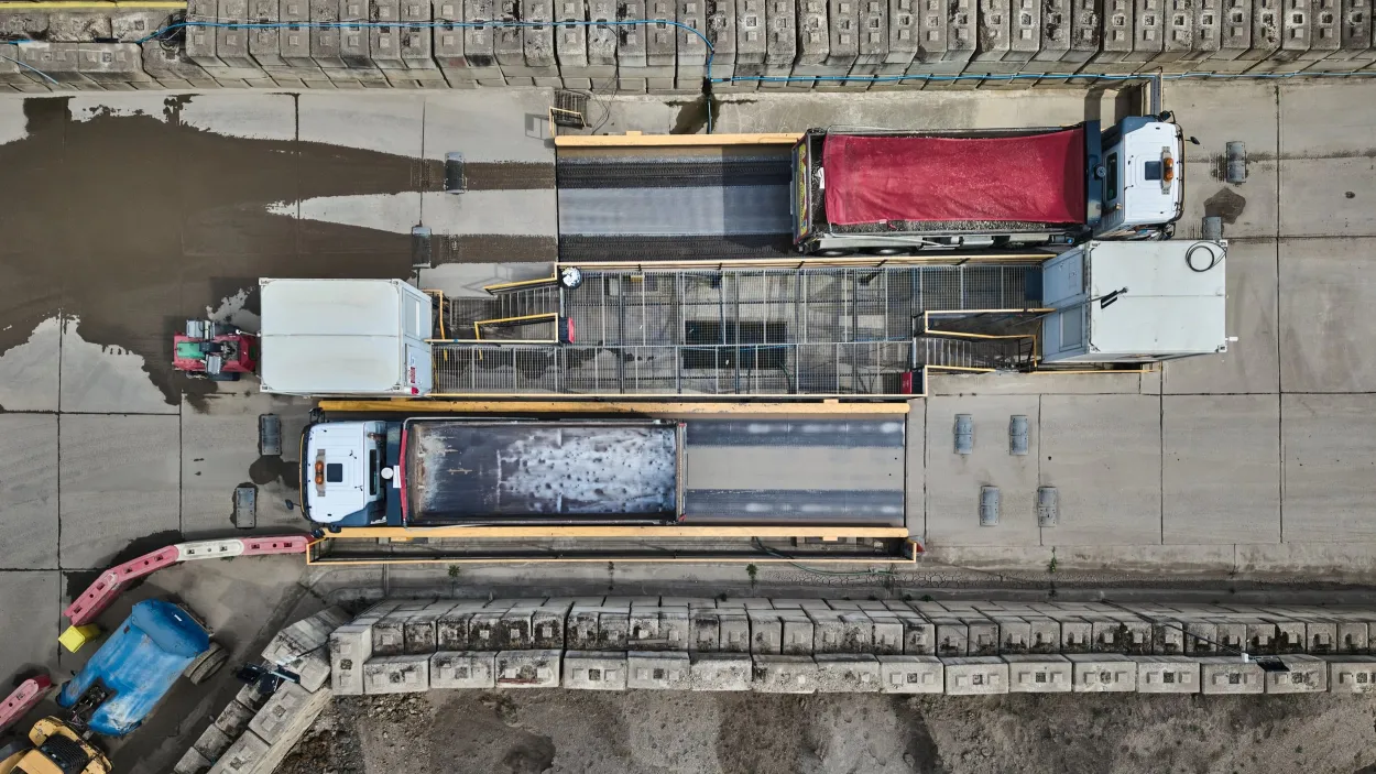 Top down image of a truck moving in and out of a weighbridge at a CDM London location.