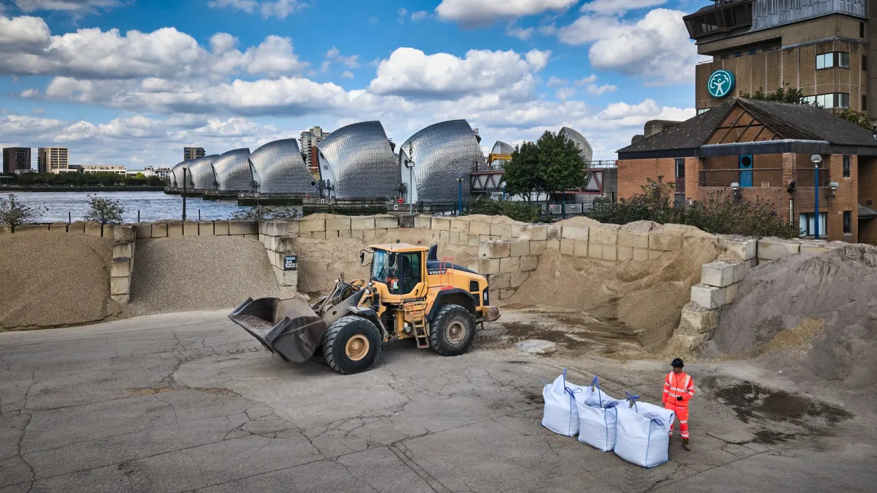 Loading shovel retrieving aggregates from storage areas