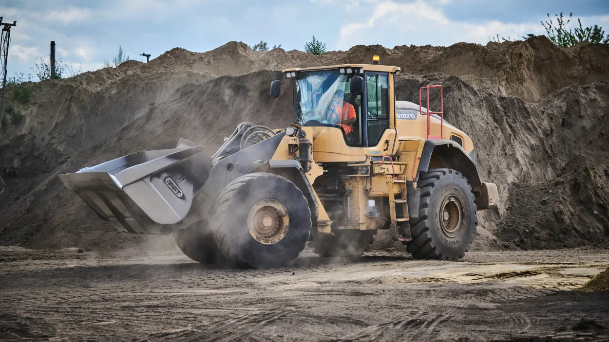 Loading Shovel moving through piles of soil