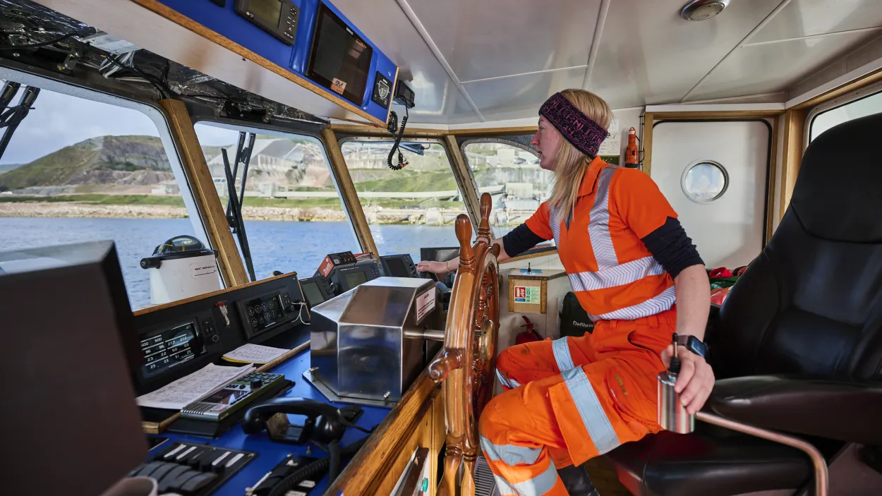 Coxswain Lawrie Cerexhe on board steering the Lady Ioana which transports colleagues and visitors from the mainland to Holcim's Glendsanda super quarry