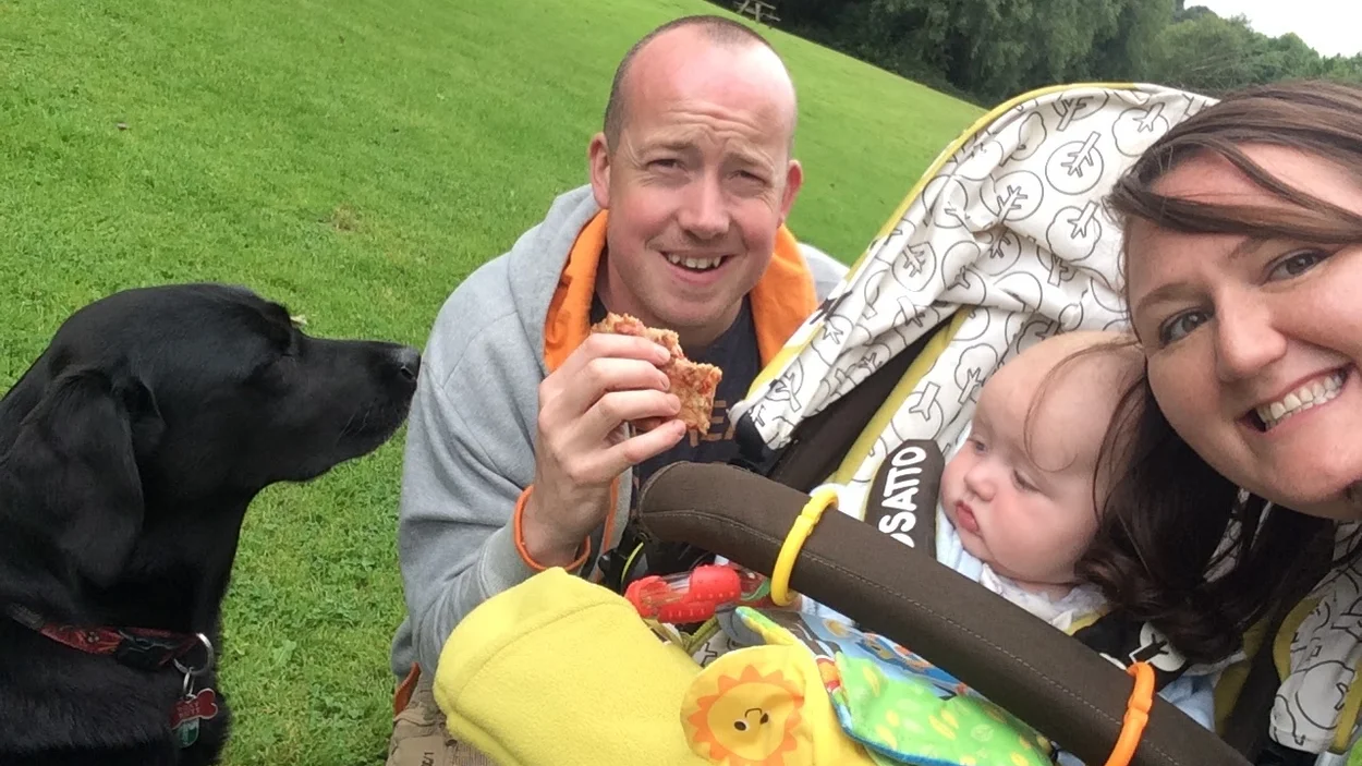 Rob Nutt with is family including his black labrador dog on a walk