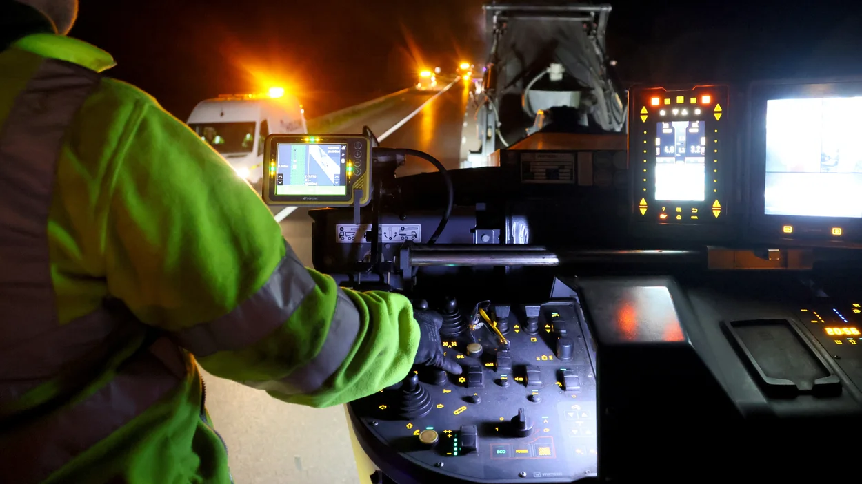 A worker overlooks the M5 motorway as he operates a piece of plant machinery