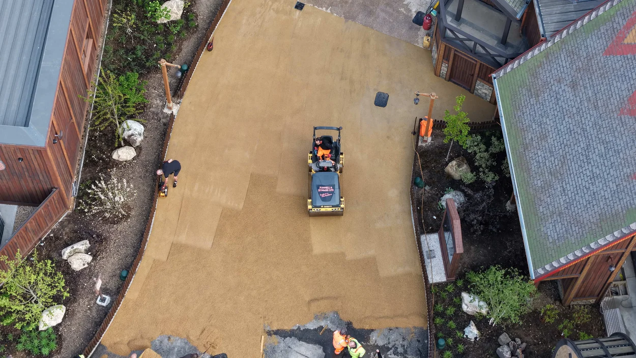 An aerial view of contractors laying Holcim's Supercolour Ultra Buff at Paulton Park new Valgard- Realm of the Vikings area