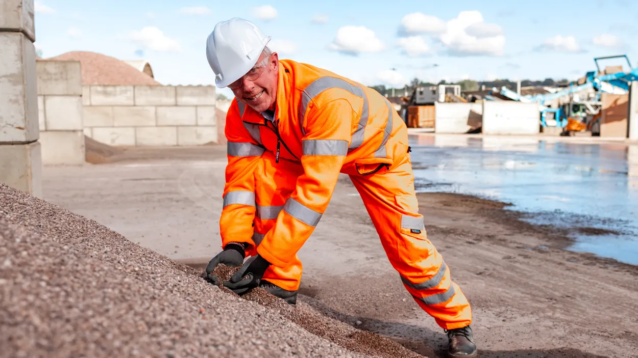 Rob Walsh picking up recycled aggregate from a pile at Land Recovery in Stoke.
