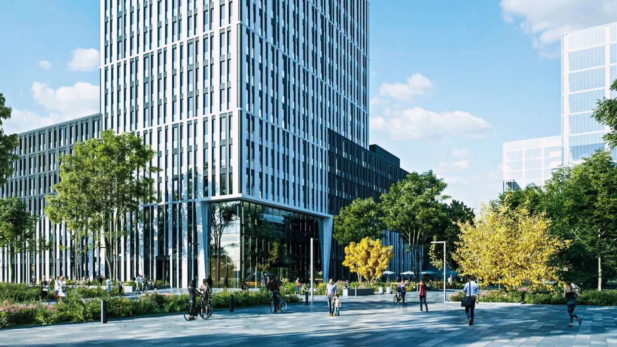 park area with people walking around and a large building in the midgroud