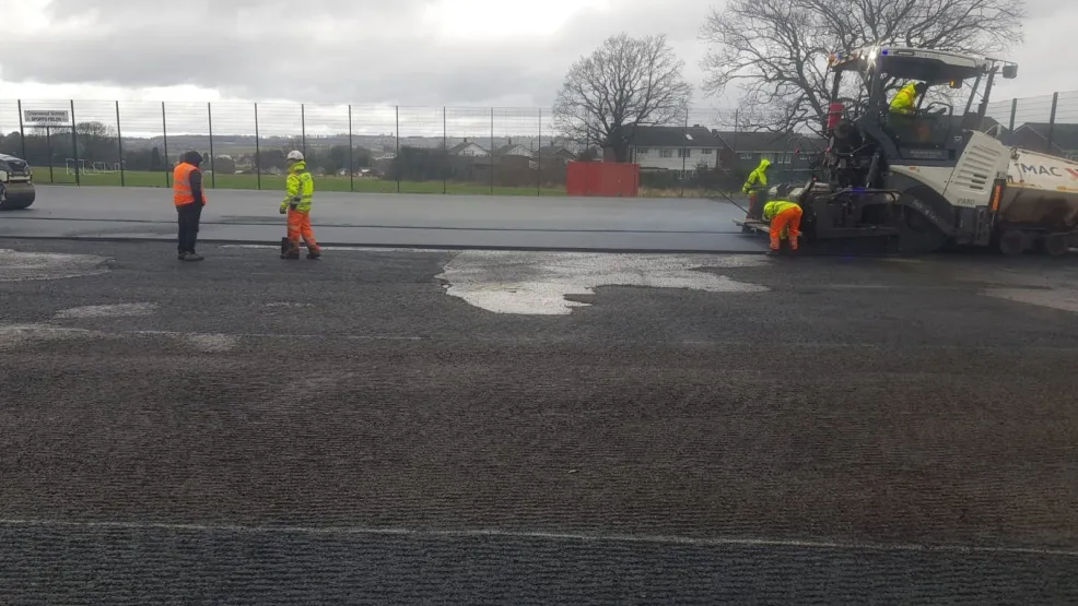 MAC surfacing workers discussing the laying process