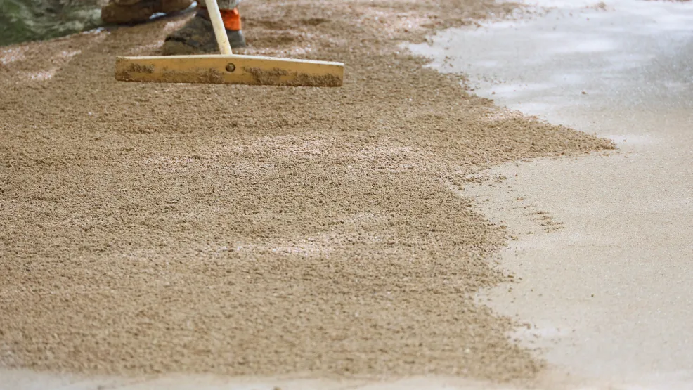 Worker manipulating SuperColour Ultra asphalt into place