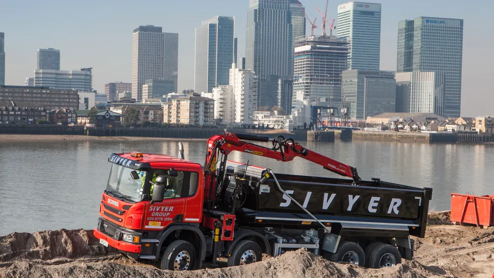 Sivyer truck driving in front of London skyline
