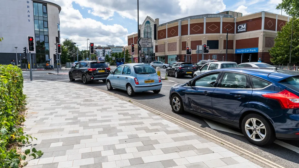 Grey block paving next to a busy road in Crawley