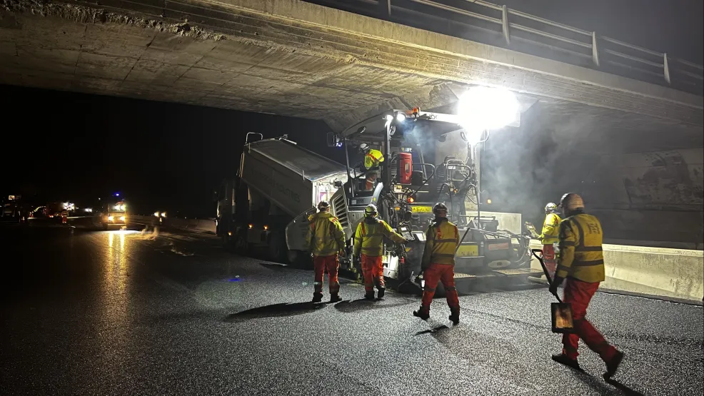 Laying Warm Mix Asphalt on the M1 under a bridge