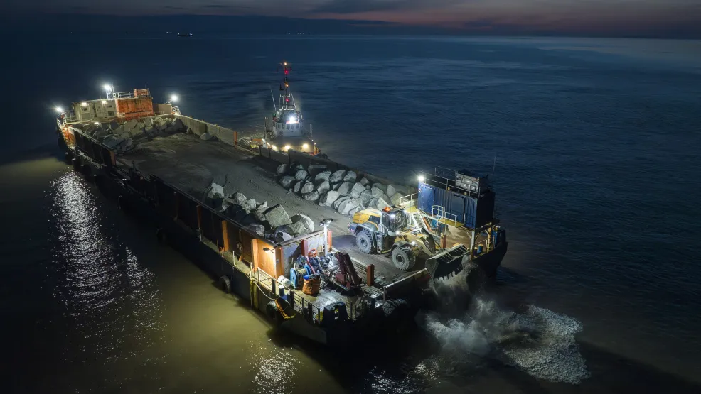 Rockarmour being delivered to the Blue Anchor coastline by the SeaRock barge at night