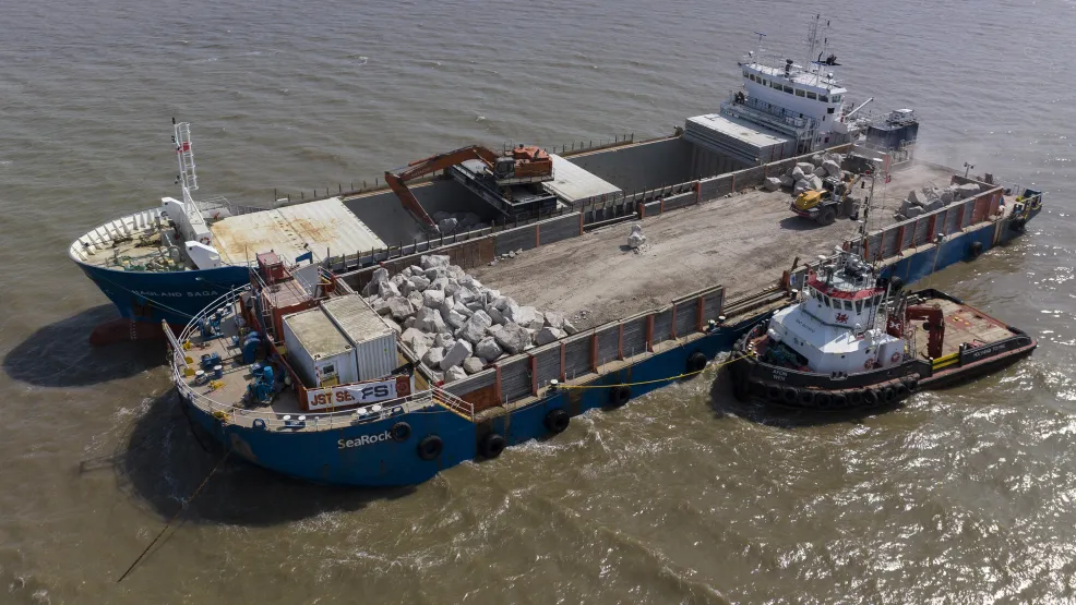 Hagland Saga transportation boat next to the SeaRock barge and a tug boat on the Blue Anchor coastline