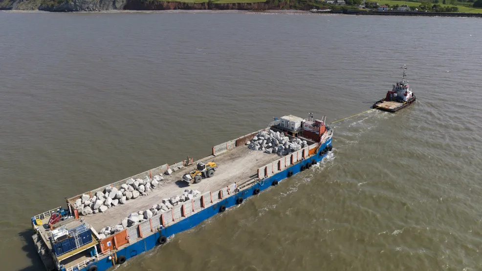Tug boat moving the SeaRock barge into position on the Blue Anchor coastline