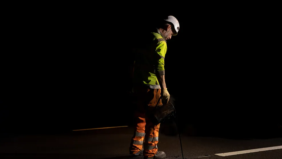Worker pouring tar equivalent to set a catseye on the A90