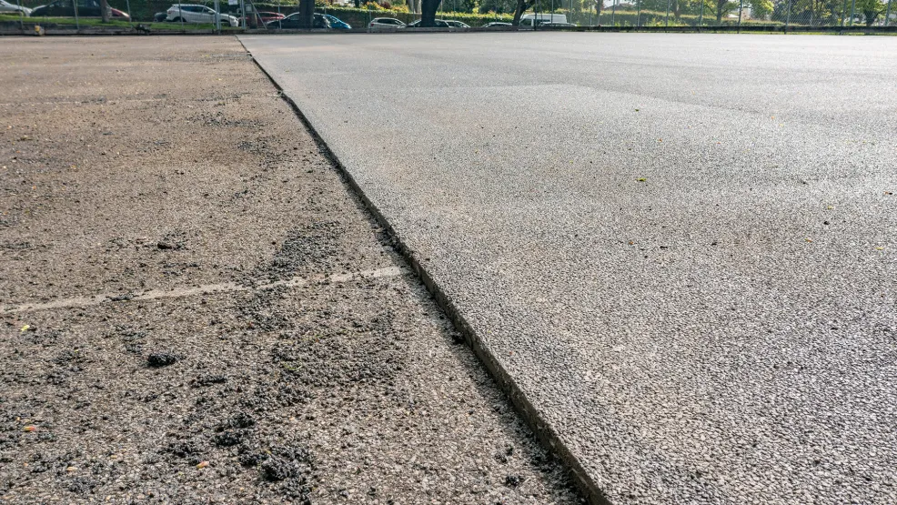 old asphalt having been planed off the surface in a straight line