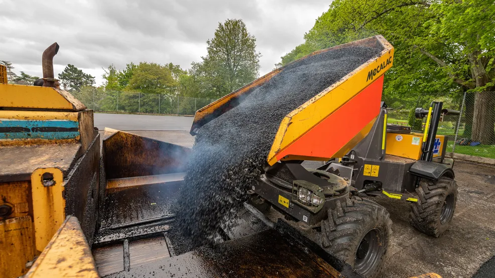 asphalt being poured into a paver