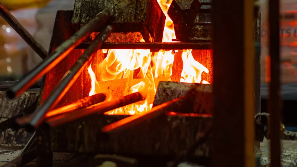 Flames heat up irons that lay road markings