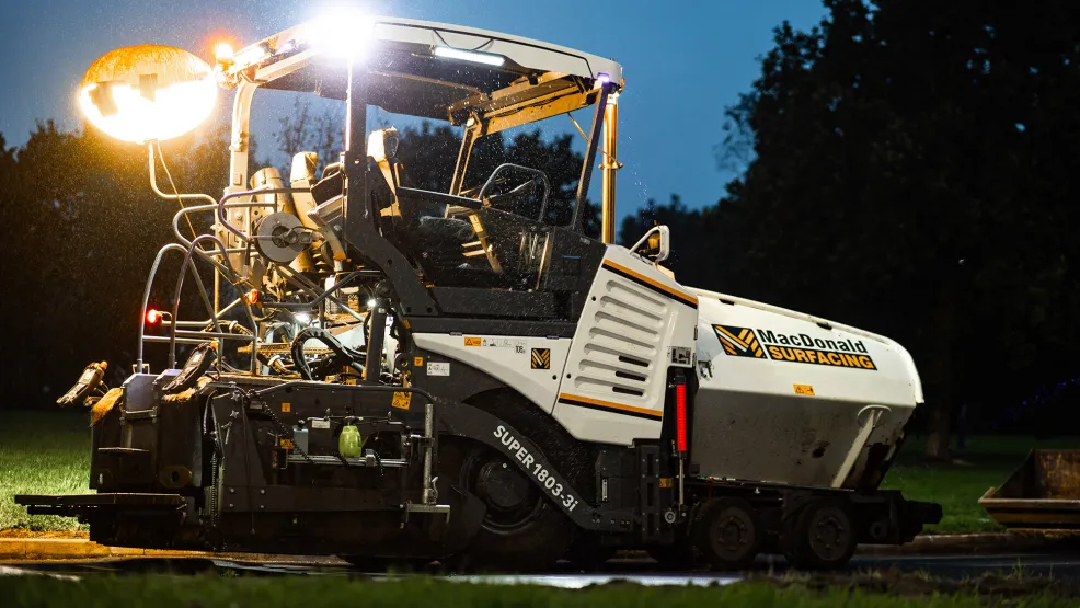 MacDonald Surfacing paver with a large light at the back to illuminate the paved area