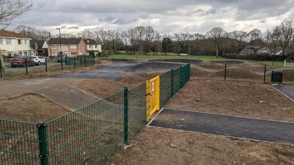 completed Pump Track with fence and gate around it
