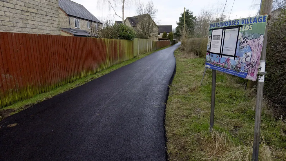 Freshly laid path next to a Waterhouses community noticeboard