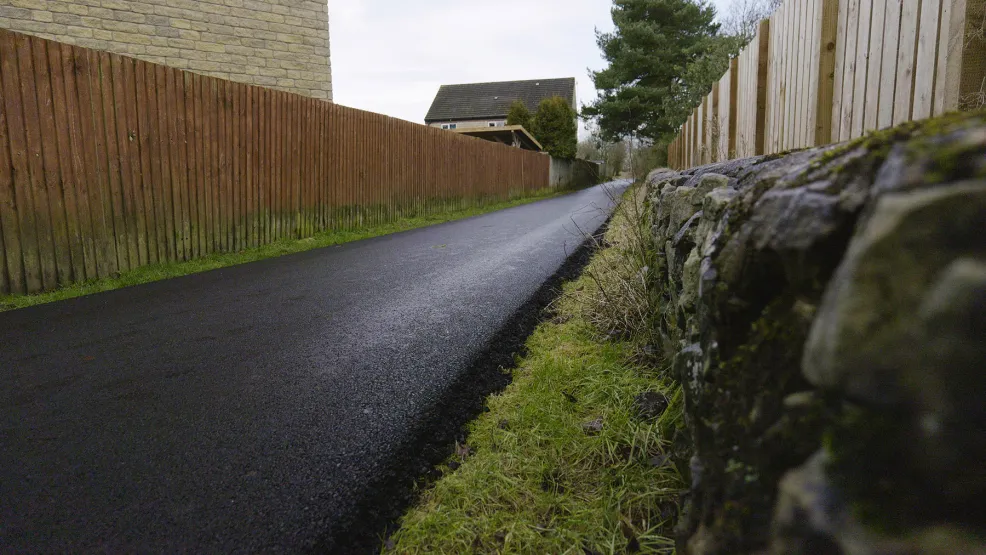 Freshly laid path with a stone wall next to Waterhouses, Staffordshire