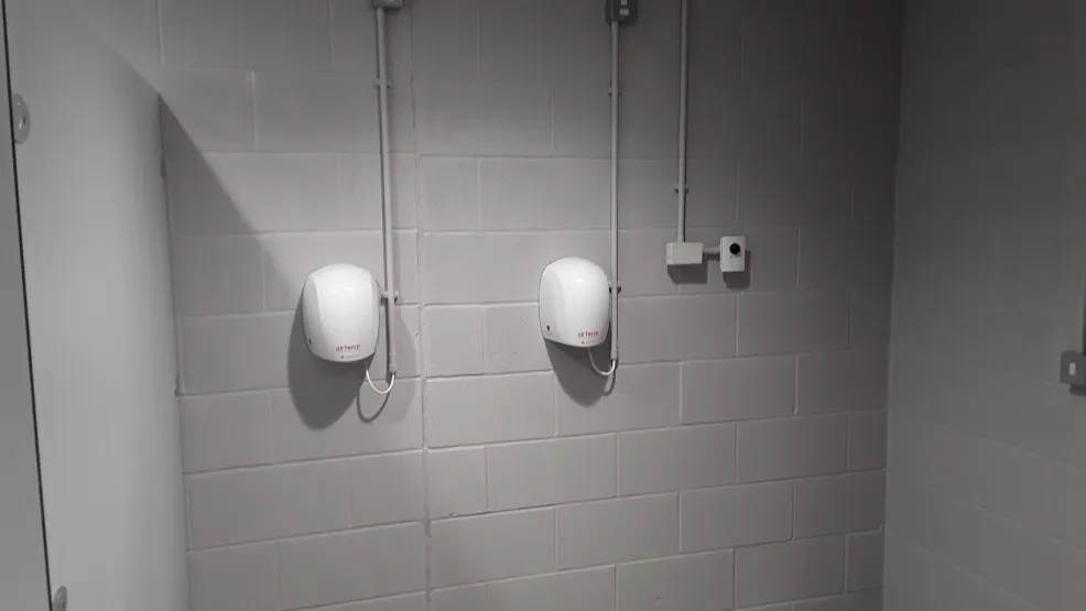 Masterlite Pro Fairfaced in situe used for a wall in a toulet block with hand dryers on the wall