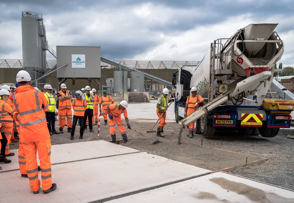 Visitors look on as EcoPact Prime AS mix is poured at the SRM Concrete site in Manchester.