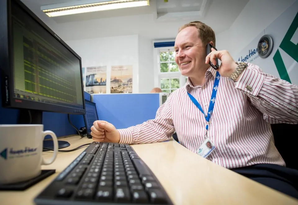 Man on the phone form contact centre at AI