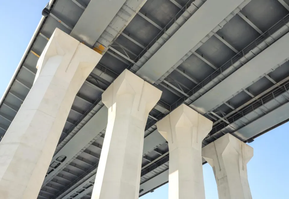 Underside shot of a bridge with concrete pillars