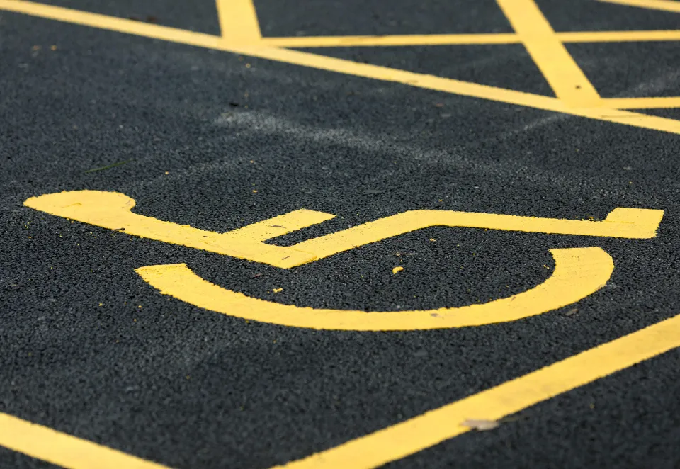 disabled bay in a carpark in yellow lining