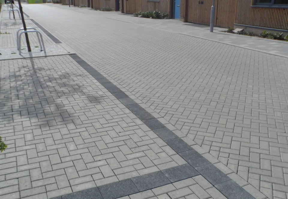 An image of Charcon's Europa Infilta laid in a herringbone pattern in Grey on a housing estate