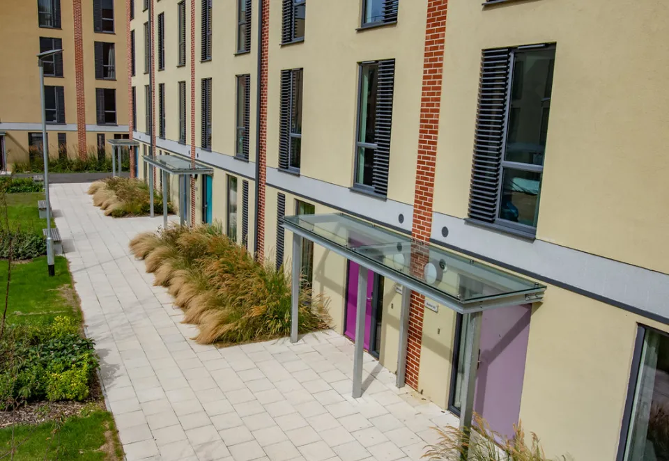 An image of Charcon's homebuilder flag in buff laid outside an apartment block