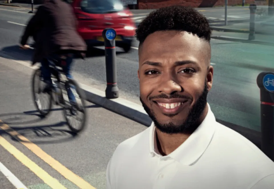 An image of a model standing infront of a busy cycle lane with the charcon logo branded on the front of the image
