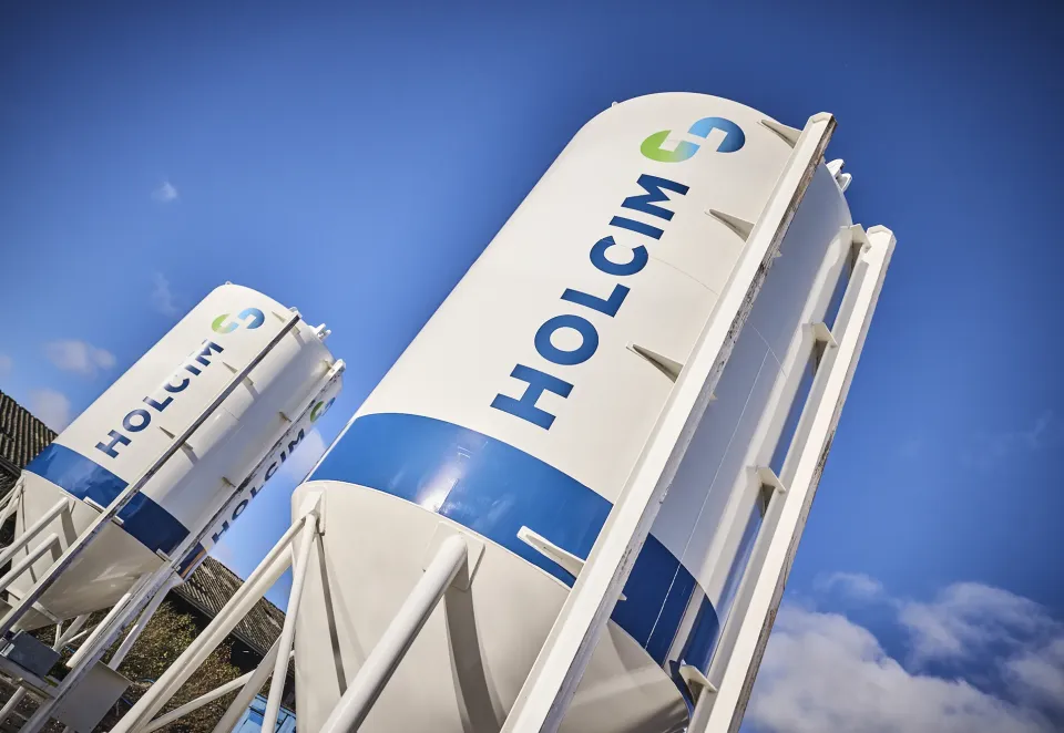 Two dry mortar silos with Holcim logo on the side