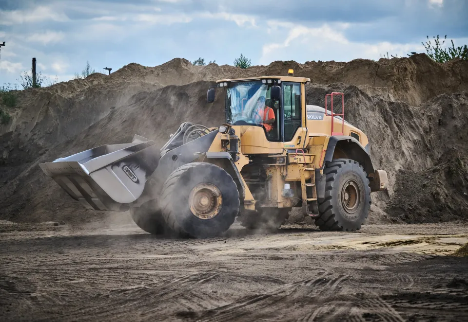 Loading Shovel moving through piles of soil